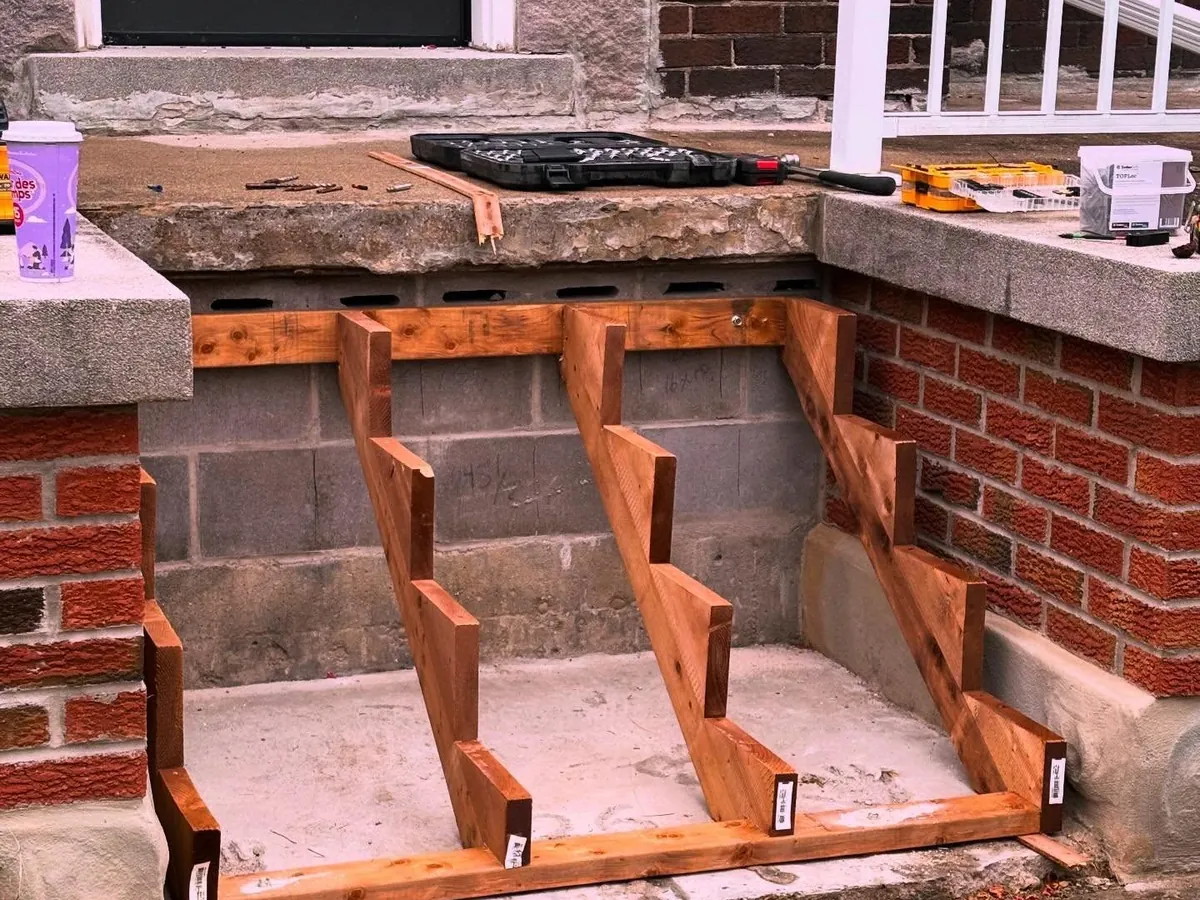 Wood stair stringers set against a porch.